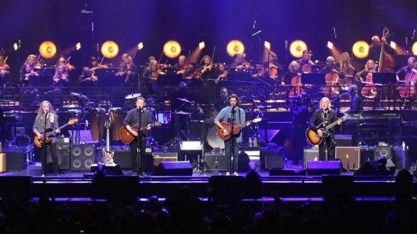 The Eagles playing on stage in front of packed crowd